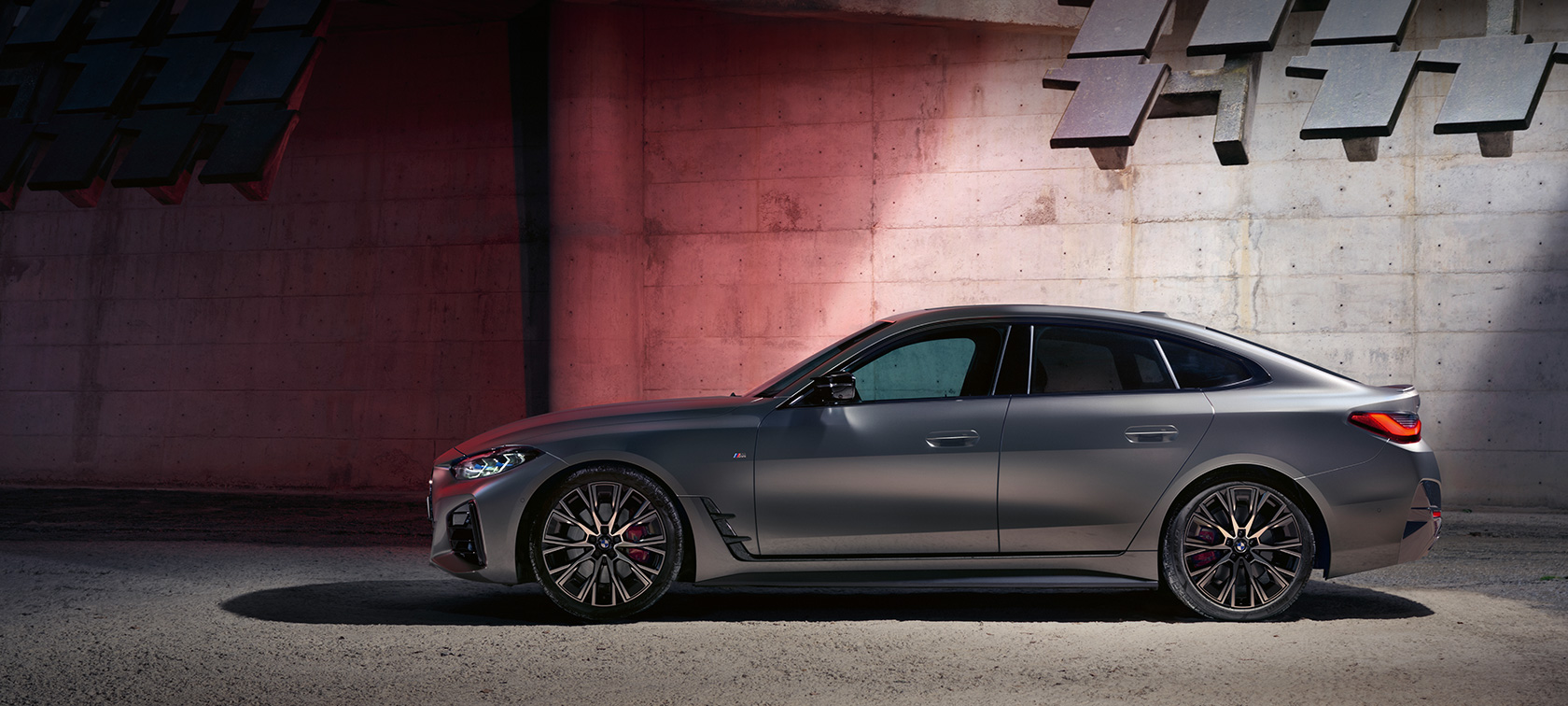 BMW M440i xDrive Gran Coupé G26 2021 vue de profil devant un mur BMW M440i xDrive Gran Coupé G26 2021 BMW Individual Frozen Pure Grey metallic vue de profil devant un mur